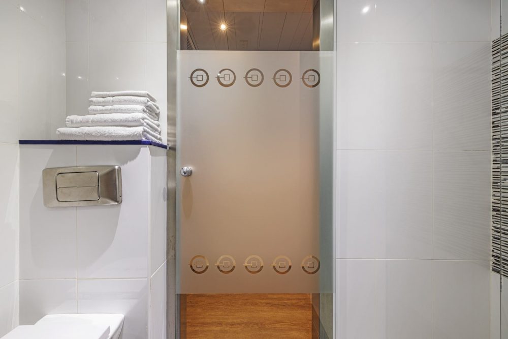 Spacious bathroom with hydromassage shower in a Superior Room at Hotel Ronda Lesseps